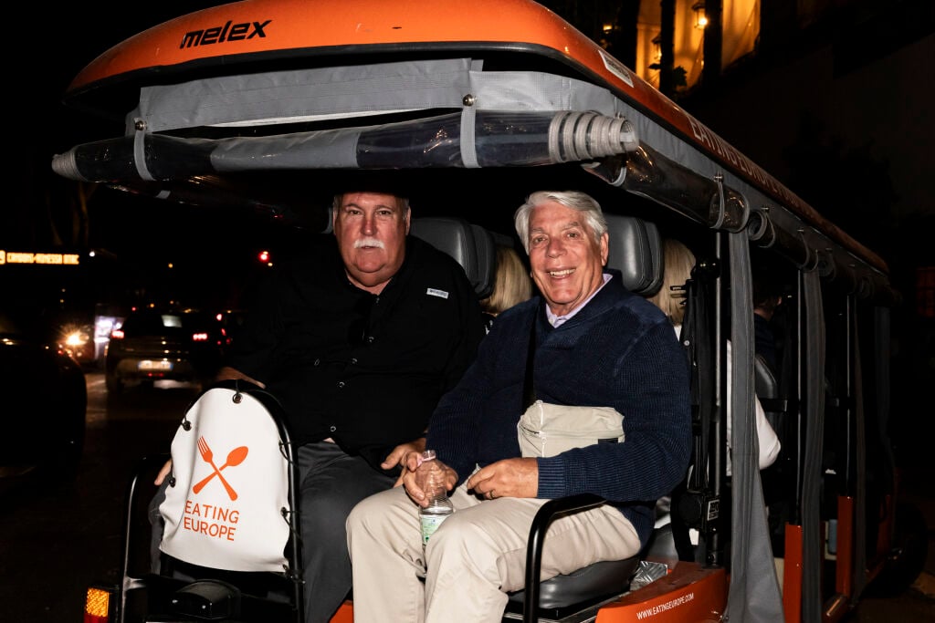 A couple on the back of a golf cart during a tour of Rome