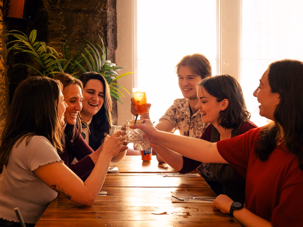 Guests raising a toast with a refreshing Scottish lager