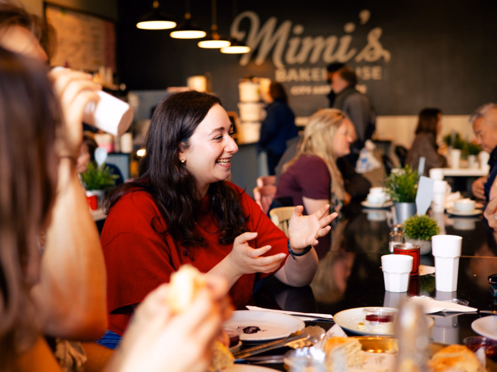 Guests enjoying an intimate atmosphere, chatting and sharing food at one of the tour stops