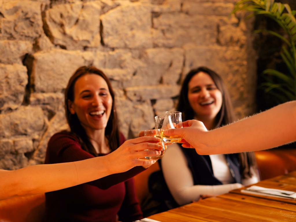 Guests raising a toast with whisky