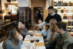 server_with_customers_at__wine_not_lisbon