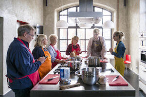 a_group_of_people_surrounding_a_table_at_an_Eating_Europe_cooking_class_in_Milan_Lombardy