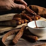 Person_dipping_churros_into_sauce_Barcelona